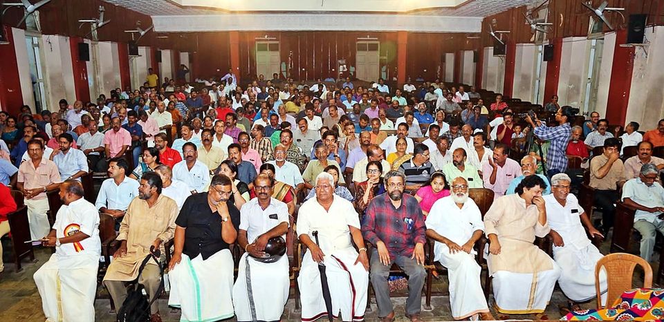 Large indoor festival audience seated for the programme