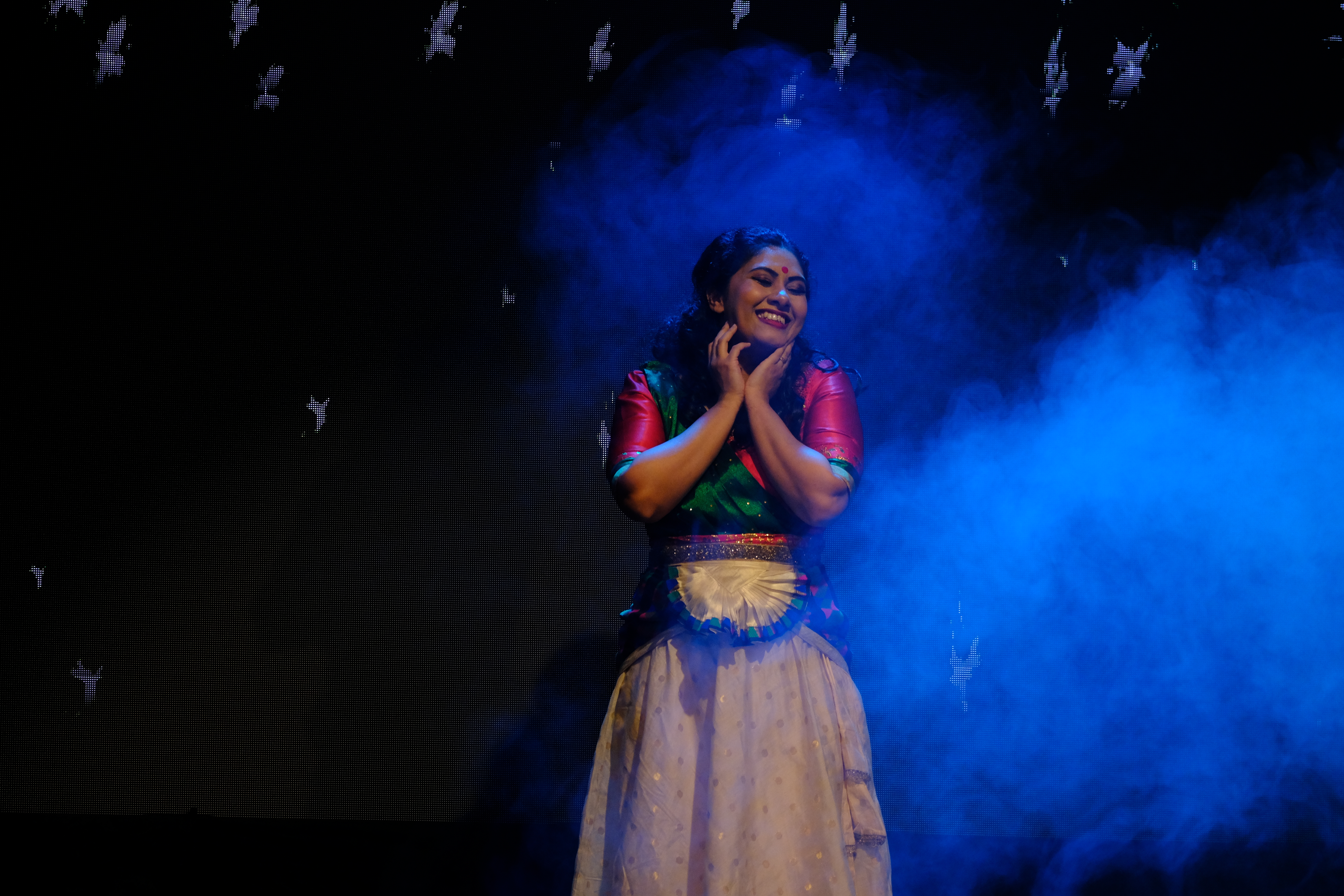 On-stage moment from Njan - Body Soul, lit in blue with stage smoke